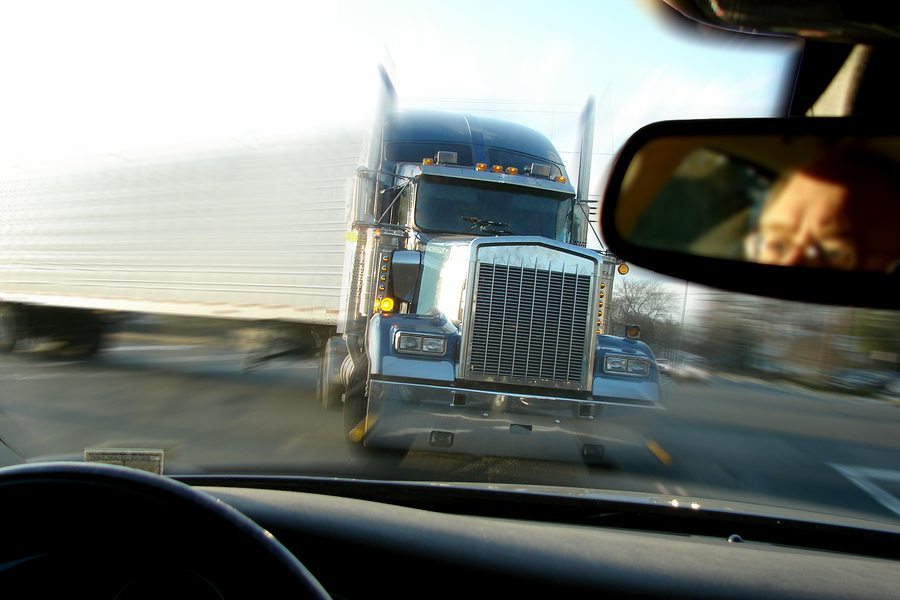 View from car driver with oncoming Tractor-trailer truck
