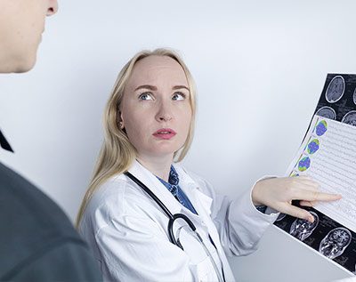 doctor showing a man with epilepsy his brain scans